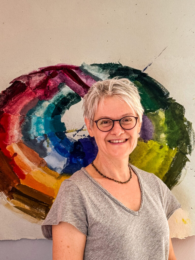 Annette Schain, founder of ColorLoop, in front of one of her painted Möbius color studies.